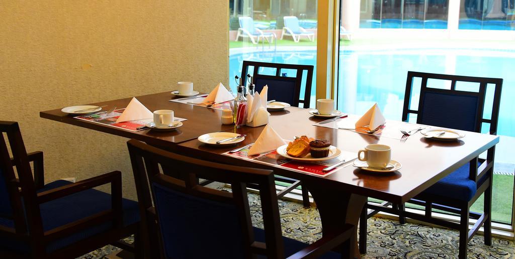 Ramada Hotel & Suites By Wyndham Al Qassim Al Bukayriah Exterior photo A table set for afternoon tea